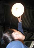 woman checking light fixture